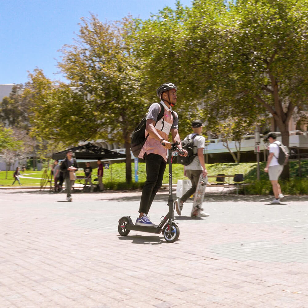 Student riding his SG5 Electric Scooter on college campus on his way to class