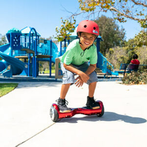 Kid riding his favorite red hoverboard in the park