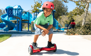 Kid riding his self-balancing hoverboard at the park