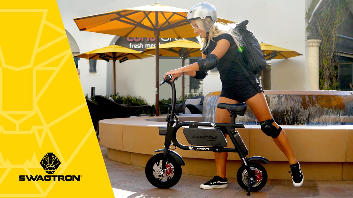 Woman wearing a helmet and getting on her swagCYCLE Pro eBike.